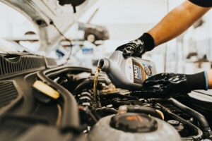 Man changing car oil 