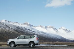 Car driving through snowy mountains 