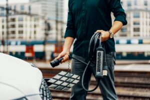 Person holding ev car charger 