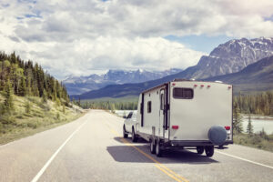 Truck pulling trailer in mountain scenery