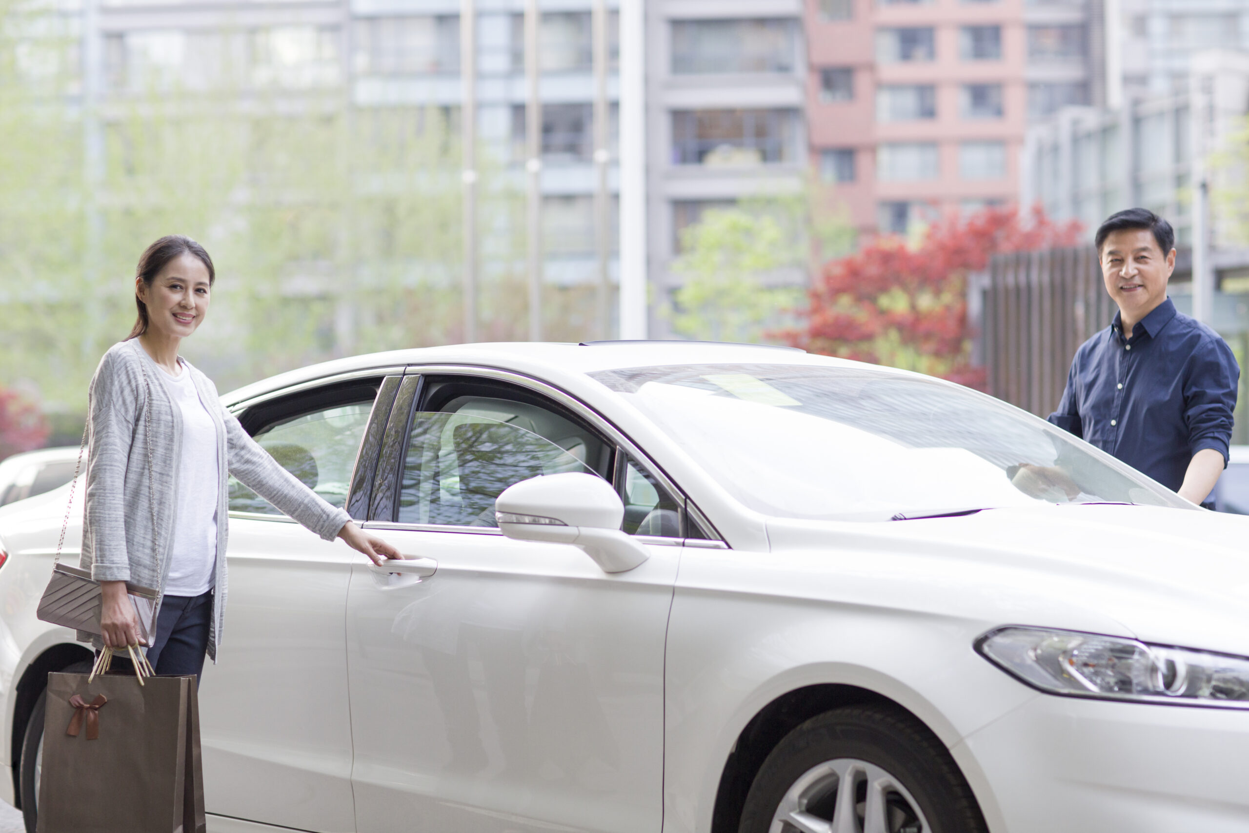 White Ford Fusion couple getting in