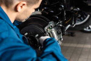 mechanic looking at brake pad